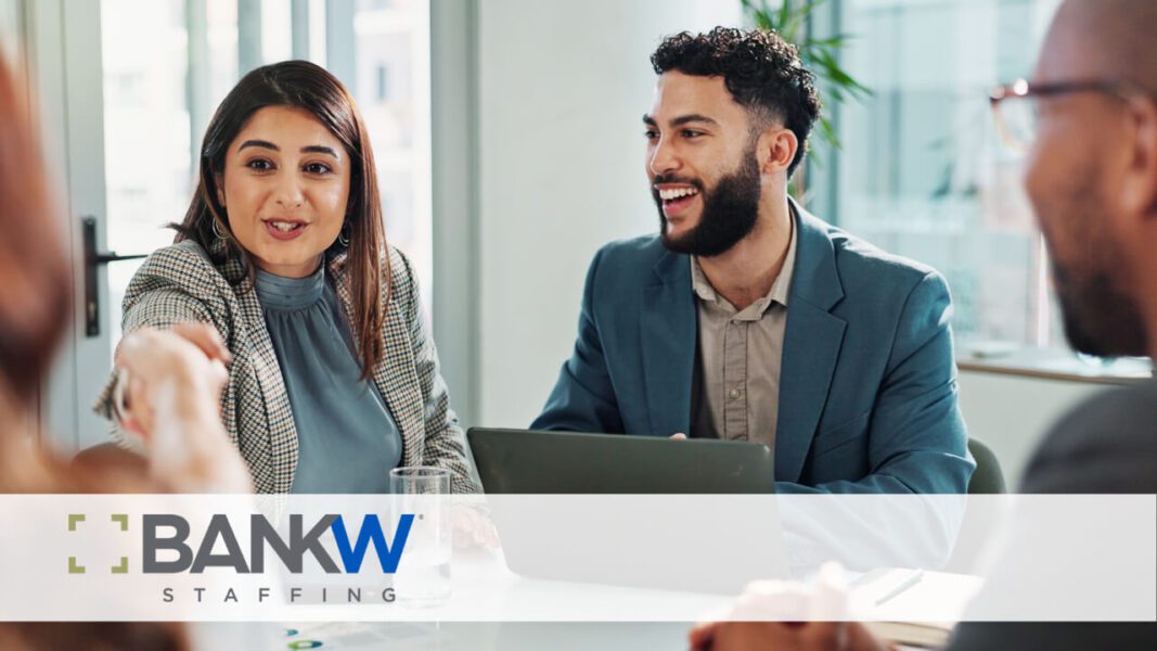People shaking hands and smiling at a table